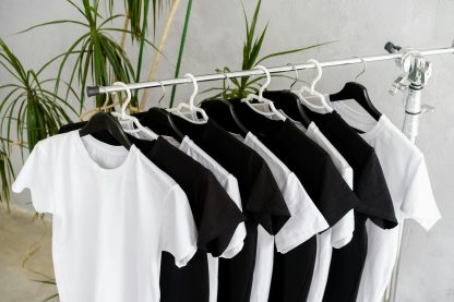 Row of black and white t-shirts hanging on rack