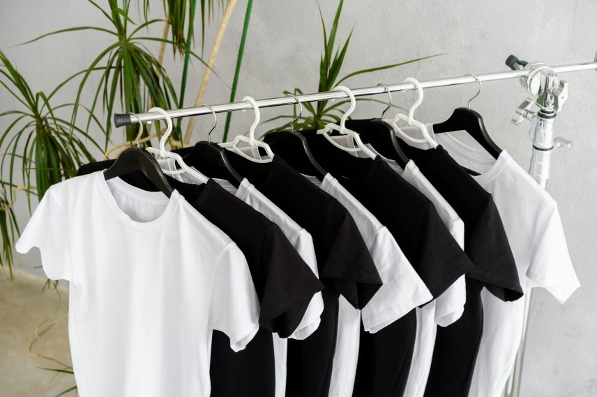 Row of black and white t-shirts hanging on rack