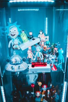 Different beam angles of LED track heads highlighting various sized collectibles in a display case