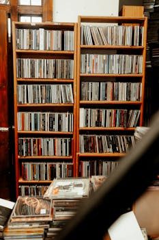 A neat row of coin albums and folders on a shelf, showcasing organized coin storage