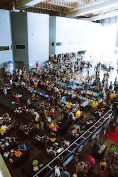 Busy collector convention hall filled with tables of vintage toys and collectibles and attendees browsing