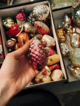 Collector carefully inspecting an antique Christmas ornament with a magnifying glass