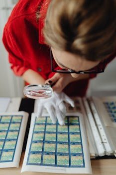 A collector inspects a vintage coin using a jeweler's loupe