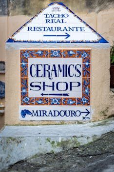 A hand-painted ceramic tile from Portugal with blue and white patterns