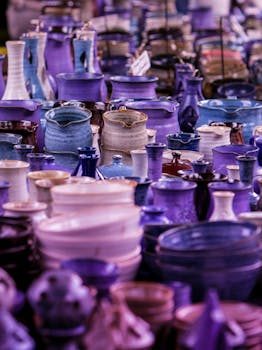 Colorful handmade ceramic bowls and mugs for sale at a European outdoor market