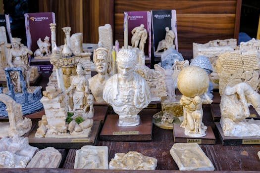 A museum gift shop display featuring replica artifacts and art prints on shelves