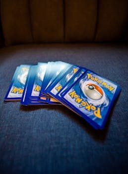 A person inspecting a Pokemon card with a magnifying glass under bright light for condition evaluation
