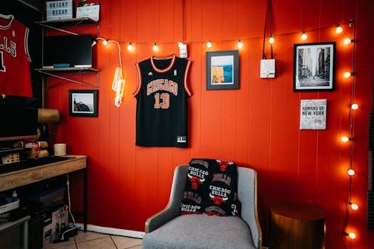 A sports jersey framed inside a black shadow box display case mounted on a living room wall