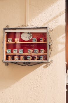 Floating shelves displaying a curated collection of travel souvenirs including masks and pottery