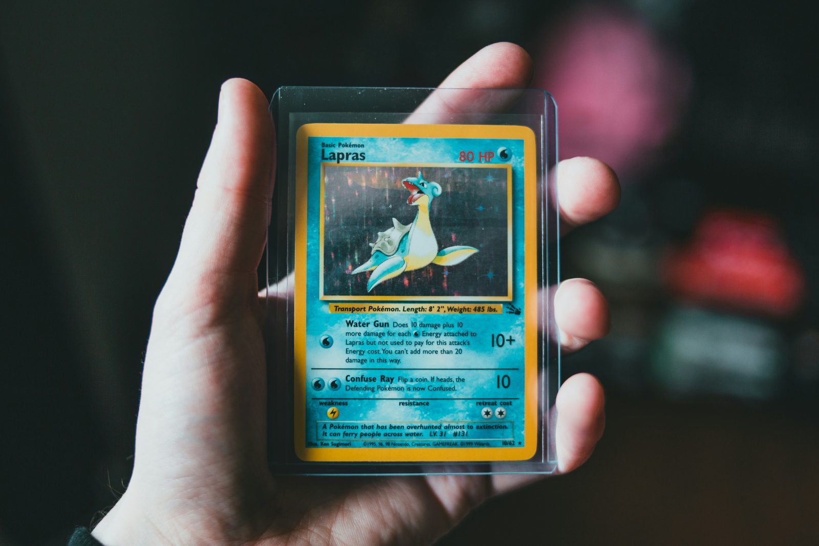 pokemon trading card on persons hand