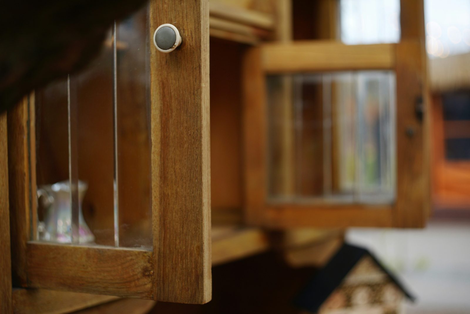 Wooden birdhouse with open door and window