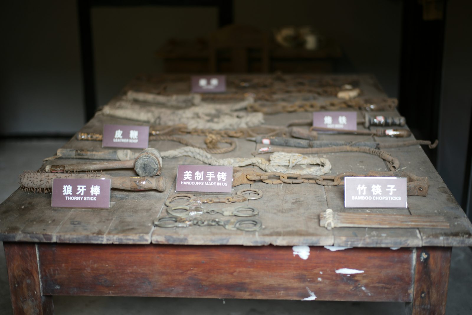 Collection of antique restraints and tools on a wooden table