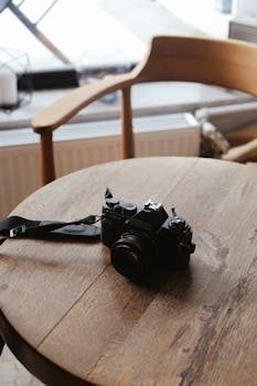 Vintage camera on a wooden table photographed with natural light