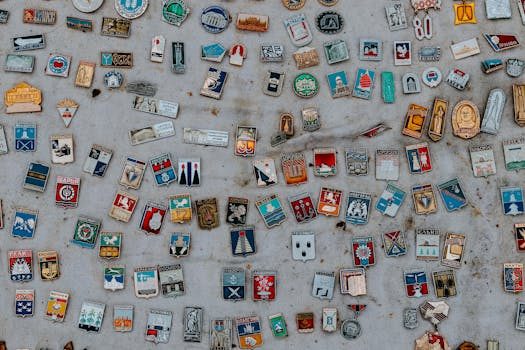 Vintage enamel keychains from a Paris flea market displayed on a wooden surface