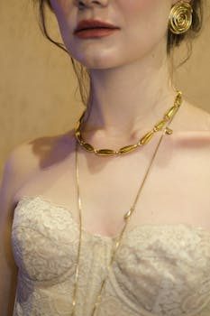 Vintage gold necklace and earrings displayed on a dark velvet surface at an estate sale