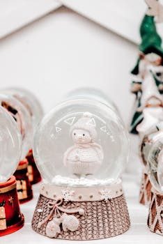 A vintage snow globe of Paris with a hand-painted Eiffel Tower scene