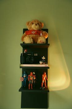 A display of vintage action figures from the 80s and 90s on shelves